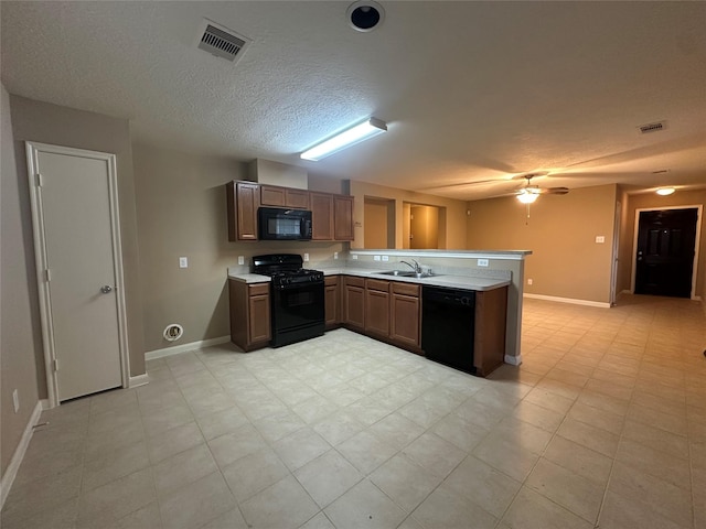 kitchen with sink, a textured ceiling, ceiling fan, kitchen peninsula, and black appliances