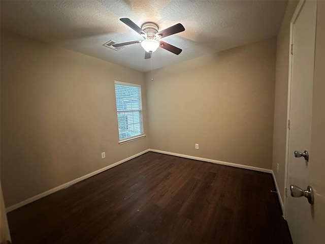 unfurnished room featuring a textured ceiling, ceiling fan, and dark hardwood / wood-style floors