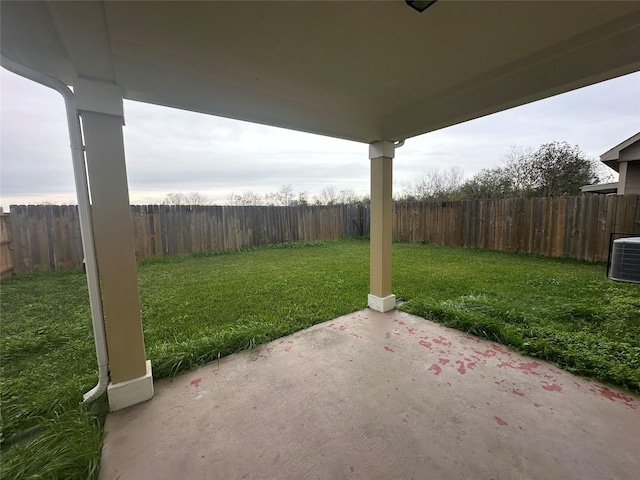 view of yard featuring central AC unit and a patio