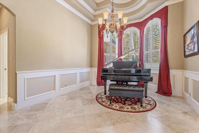 misc room with a notable chandelier, a raised ceiling, and crown molding