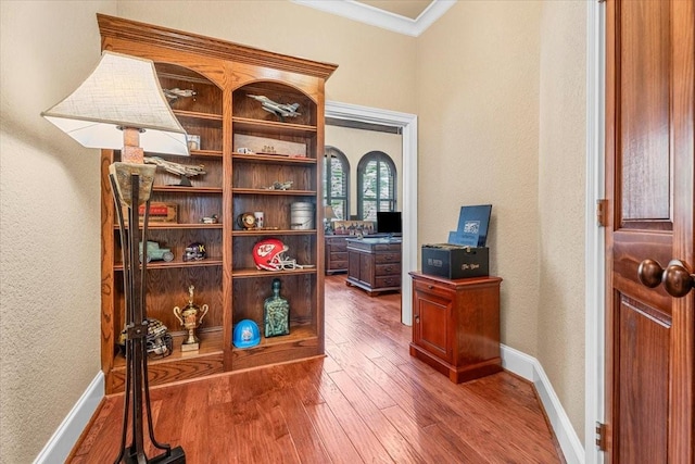 interior space with ornamental molding and dark wood-type flooring