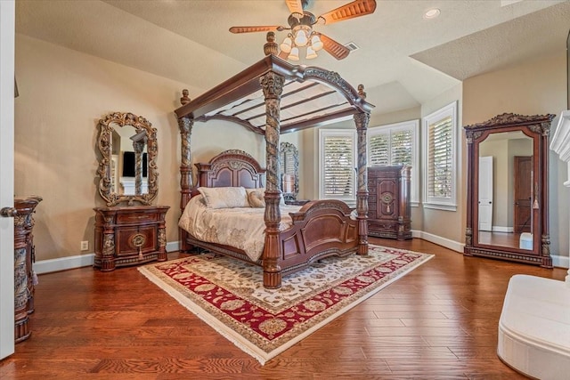 bedroom featuring a textured ceiling, ceiling fan, vaulted ceiling, and dark wood-type flooring