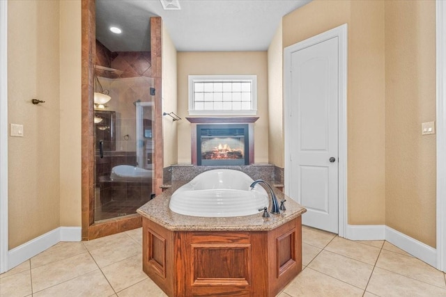 bathroom featuring tile patterned flooring and independent shower and bath