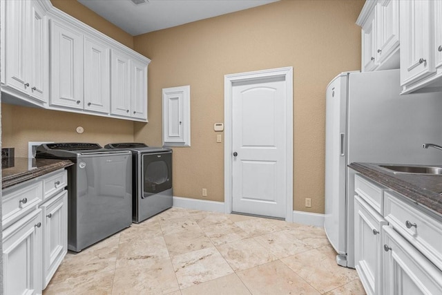 laundry room with sink, cabinets, and washing machine and dryer