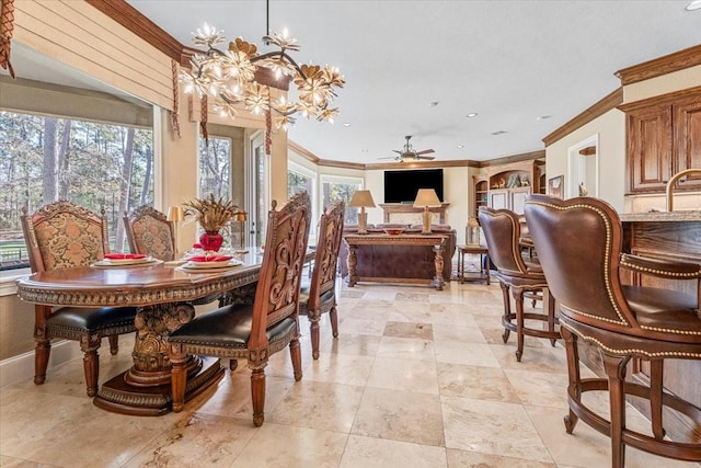 dining space with ceiling fan with notable chandelier and crown molding