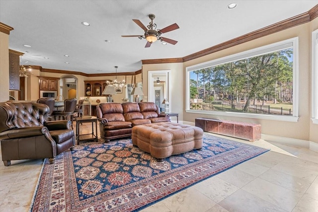 living room featuring ceiling fan with notable chandelier and ornamental molding