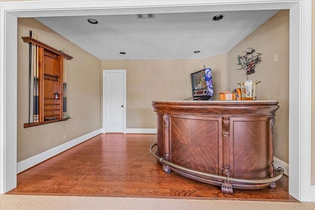 bar with hardwood / wood-style floors