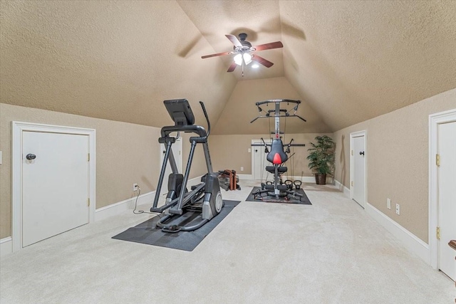 exercise room featuring lofted ceiling, a textured ceiling, ceiling fan, and carpet flooring