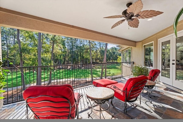 sunroom featuring french doors and ceiling fan