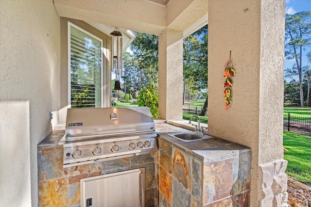 view of patio with sink and area for grilling