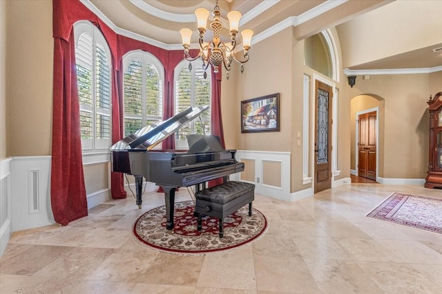 misc room with a raised ceiling, ornamental molding, and an inviting chandelier