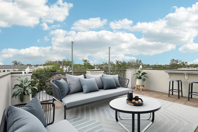 view of patio with exterior bar, a balcony, and an outdoor hangout area