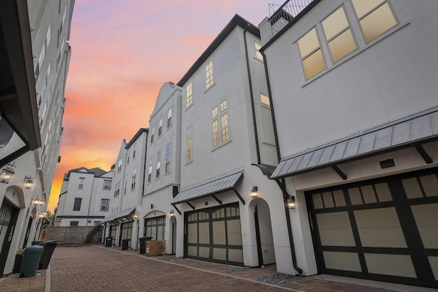 outdoor building at dusk with a garage