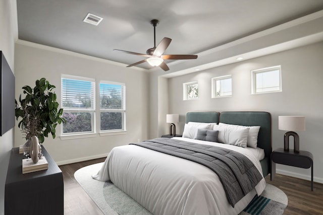 bedroom with ornamental molding, ceiling fan, and dark hardwood / wood-style floors