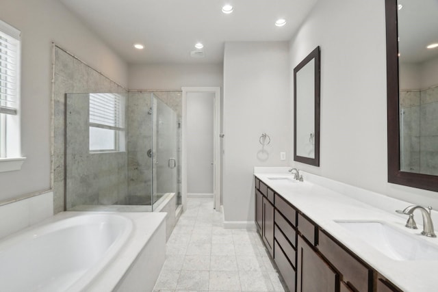 bathroom featuring plus walk in shower and vanity