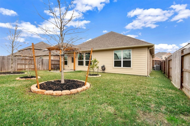 rear view of property featuring cooling unit and a yard