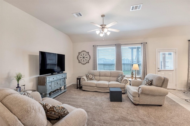 living room featuring plenty of natural light, light colored carpet, lofted ceiling, and ceiling fan