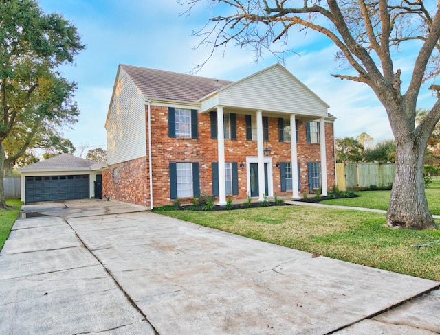 neoclassical / greek revival house featuring a front lawn and a garage