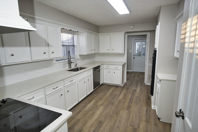 kitchen featuring sink, white cabinetry, a textured ceiling, stainless steel dishwasher, and exhaust hood