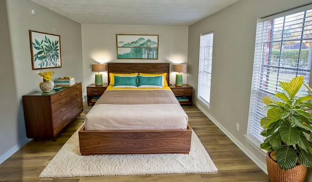 bedroom with dark wood-type flooring