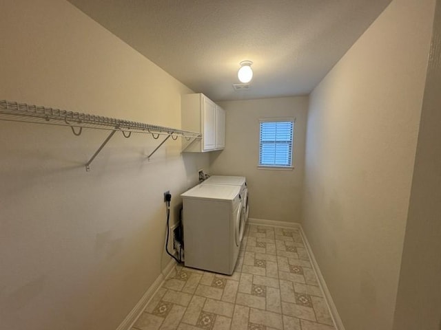 clothes washing area featuring washer / clothes dryer and cabinets