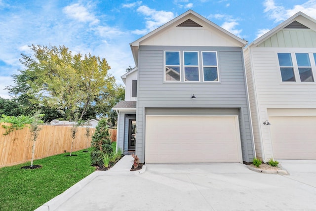 view of front of house with a front yard and a garage