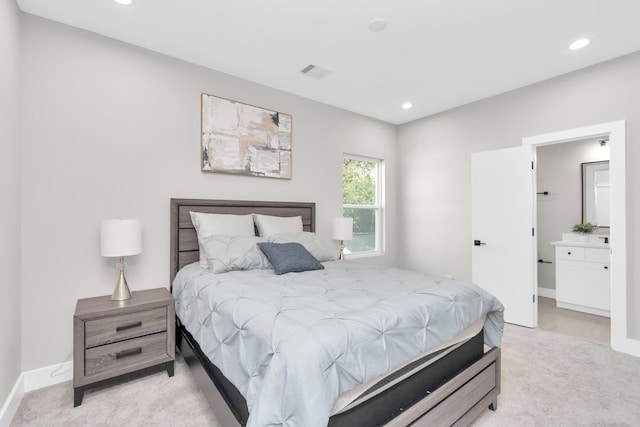 carpeted bedroom with ensuite bath