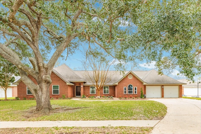 ranch-style home featuring concrete driveway, an attached garage, brick siding, and a front lawn