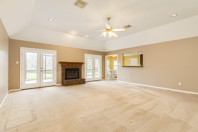 unfurnished living room featuring baseboards, french doors, visible vents, and light carpet