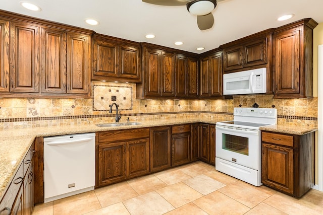 kitchen featuring light stone countertops, white appliances, sink, ceiling fan, and light tile patterned floors