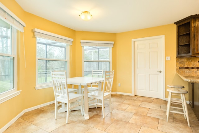 dining room with light tile patterned flooring and baseboards
