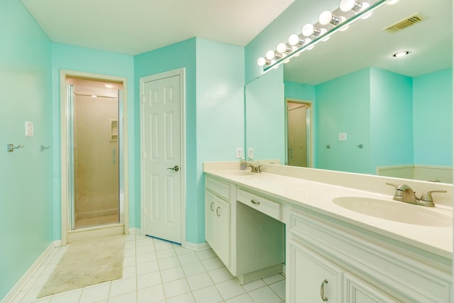bathroom with visible vents, a stall shower, and a sink