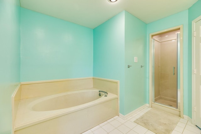 full bathroom with a bath, baseboards, tile patterned flooring, and a shower stall