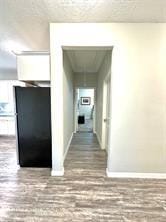 hallway with hardwood / wood-style flooring