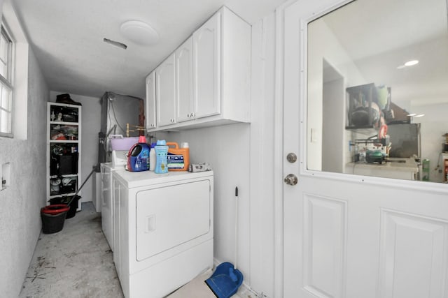 laundry area with washer / dryer and cabinets