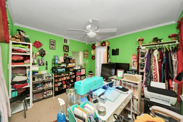 home office with ornamental molding, ceiling fan, and carpet