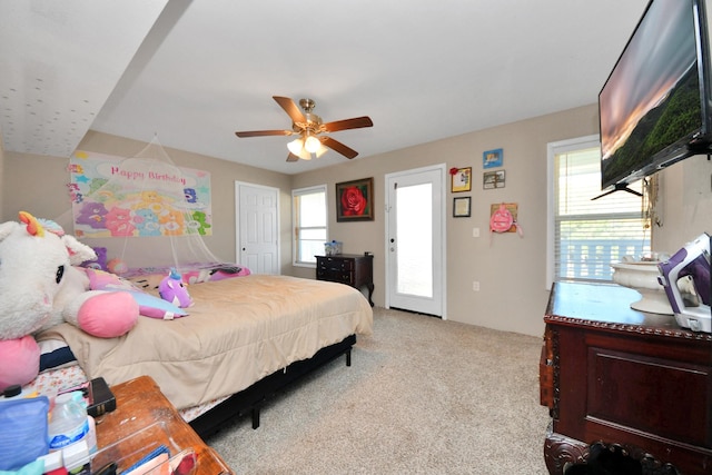 bedroom featuring ceiling fan and light carpet