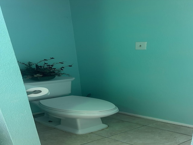 bathroom featuring toilet and tile patterned flooring