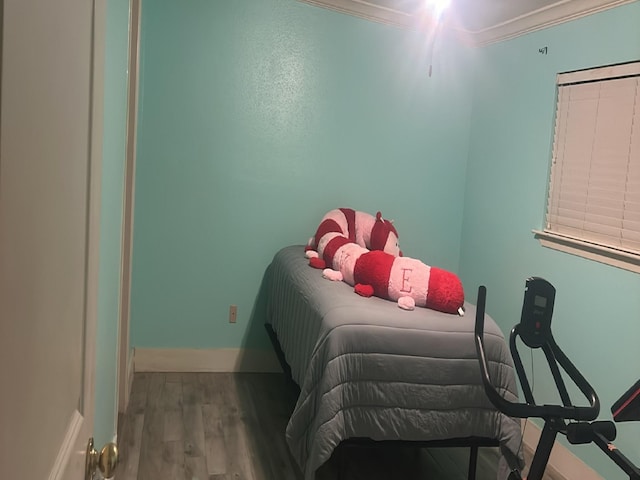 bedroom featuring ornamental molding and wood-type flooring