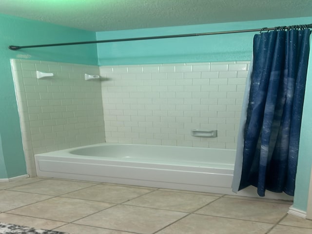 bathroom featuring shower / bathtub combination with curtain, a textured ceiling, and tile patterned floors