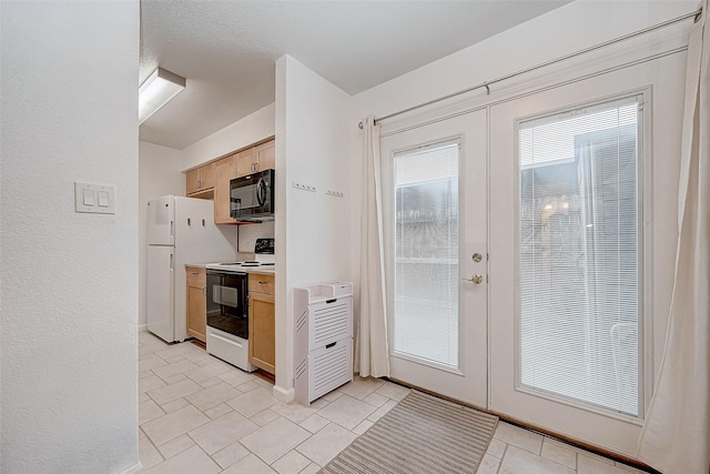 kitchen with range with electric cooktop, light tile patterned floors, french doors, and light brown cabinets