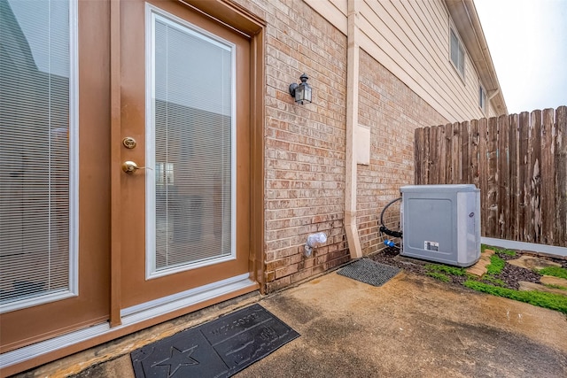 property entrance featuring ac unit and a patio area