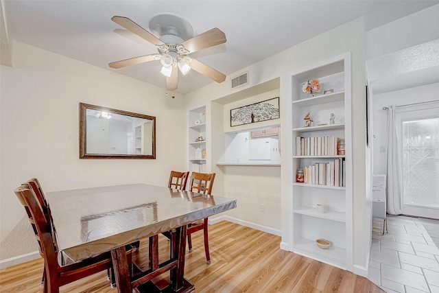 dining room featuring ceiling fan, light hardwood / wood-style flooring, and built in features