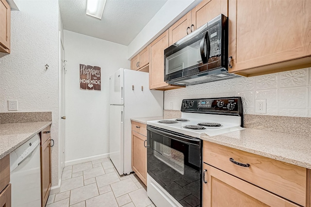 kitchen with white appliances, light tile patterned flooring, light brown cabinetry, and light stone counters