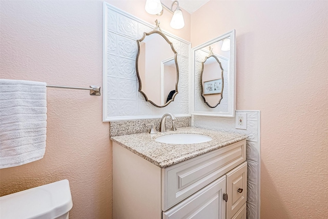 bathroom with toilet and vanity