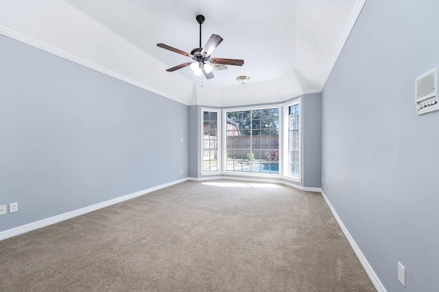 carpeted spare room with lofted ceiling, ceiling fan, and ornamental molding