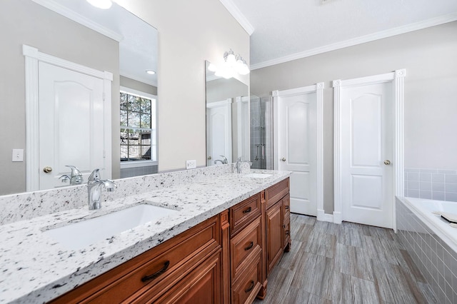 bathroom with plus walk in shower, crown molding, and vanity