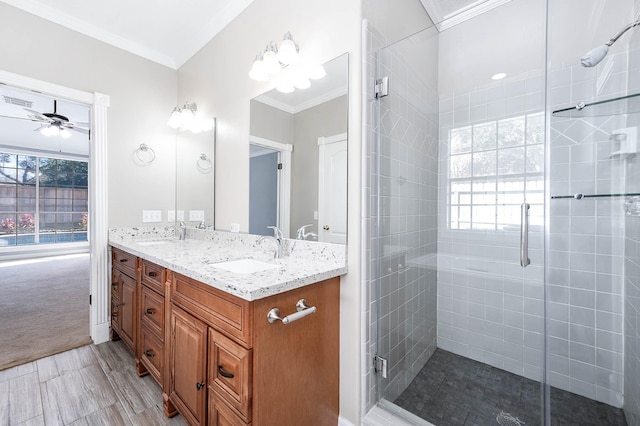 bathroom with an enclosed shower, vanity, ceiling fan, and crown molding