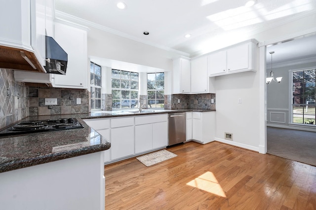 kitchen featuring white cabinets, hanging light fixtures, decorative backsplash, and black gas cooktop