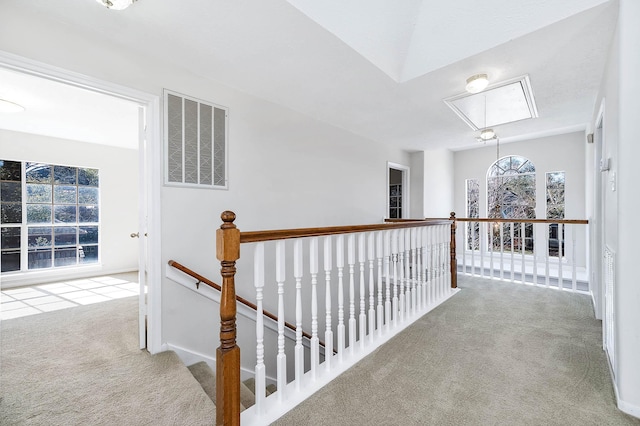 hall featuring light colored carpet